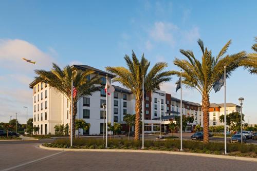 a building with palm trees in front of a street at TownePlace Suites by Marriott San Diego Airport/Liberty Station in San Diego