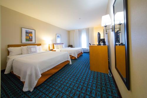 a hotel room with two beds and a television at Fairfield Inn & Suites by Marriott Cordele in Cordele