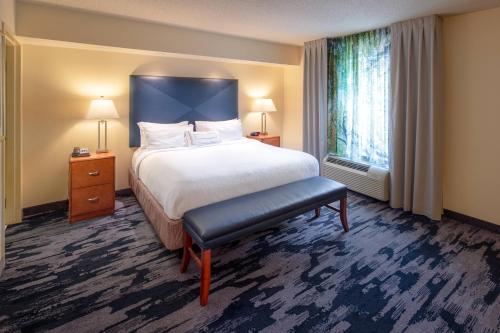 a hotel room with a bed and a large window at Fairfield Inn and Suites by Marriott South Boston in South Boston