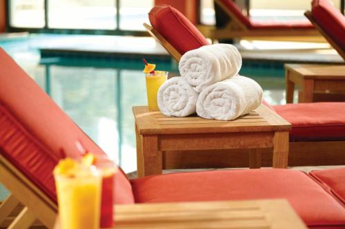 a pile of towels sitting on a table with a candle at Atlanta Airport Marriott in Atlanta