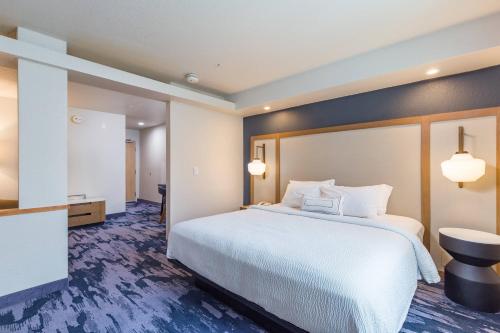 a hotel room with a large bed and a bathroom at Fairfield Inn and Suites by Marriott Tampa North in Tampa