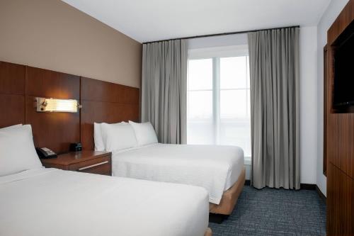 a hotel room with two beds and a window at Residence Inn by Marriott Norwalk in Norwalk