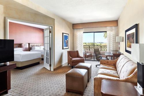 a hotel room with a bed and a living room at Scottsdale Marriott at McDowell Mountains in Scottsdale