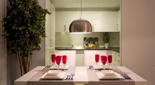 a kitchen with red wine glasses on a table at Malaga Andes Beach in Málaga