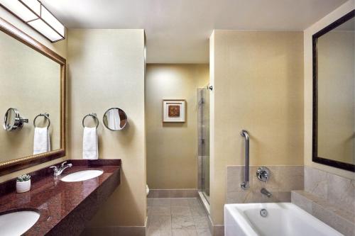 a bathroom with two sinks and a tub and a shower at Scottsdale Marriott at McDowell Mountains in Scottsdale