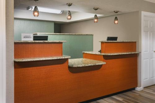 an empty waiting room with orange and brown counters at Residence Inn Hartford Windsor in Windsor