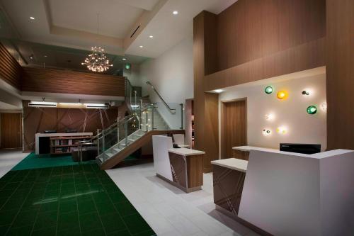 a lobby with a staircase and a green carpet at Courtyard by Marriott San Diego Gaslamp/Convention Center in San Diego