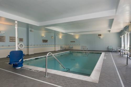 a large swimming pool in a building at SpringHill Suites by Marriott Charlotte Ballantyne in Charlotte