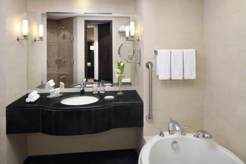 a bathroom with a sink and a tub at Courtyard Riyadh by Marriott Diplomatic Quarter in Riyadh