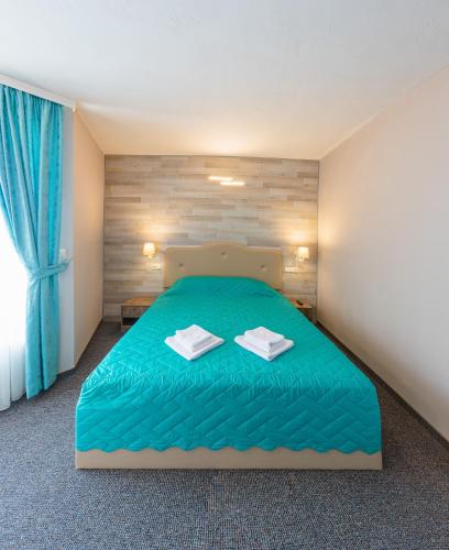 Postel nebo postele na pokoji v ubytování Lecardo Hotel