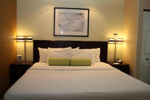 a bedroom with a large white bed with two lamps at SpringHill Suites Morgantown in Morgantown