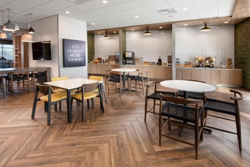 a restaurant with tables and chairs and a counter at Fairfield by Marriott Inn & Suites Dallas East in Dallas