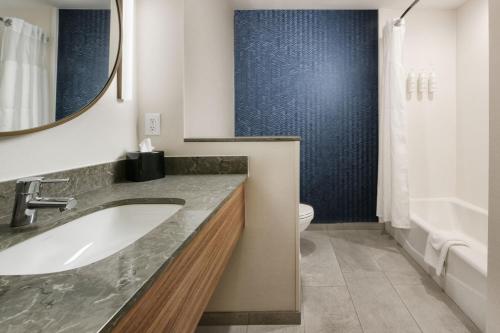 a bathroom with a sink and a toilet at Fairfield by Marriott Inn & Suites Dallas East in Dallas