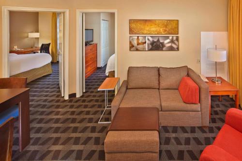 韋斯頓的住宿－勞德代爾堡韋斯頓萬豪廣場套房酒店，酒店客房设有一张沙发和一张床