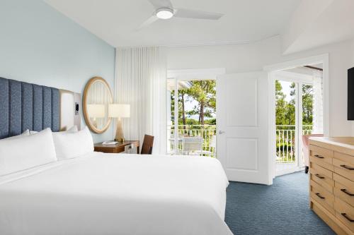 a hotel room with a bed and a balcony at Marriott's SurfWatch in Hilton Head Island