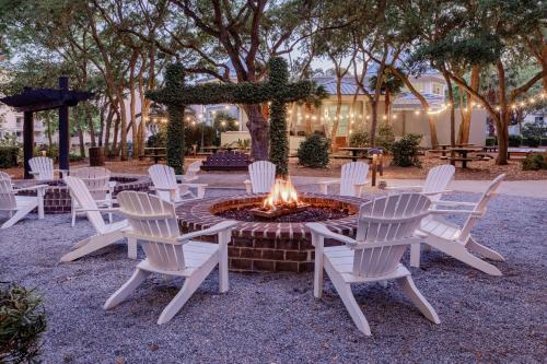 a group of white chairs around a fire pit at Marriott's SurfWatch in Hilton Head Island