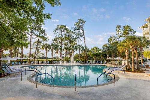 a swimming pool at a resort with trees at Marriott's SurfWatch in Hilton Head Island