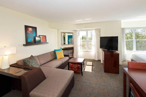 a living room with a couch and a tv at Residence Inn by Marriott Evansville East in Evansville