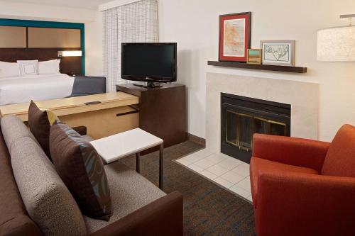a hotel room with a couch and a fireplace at Residence Inn Fremont Silicon Valley in Fremont