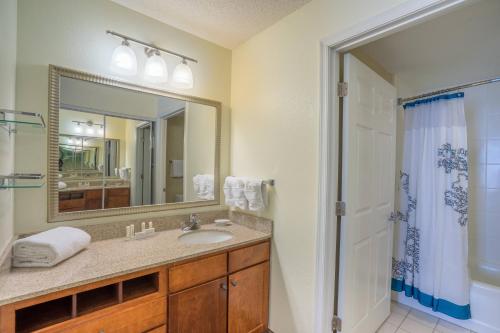 a bathroom with a sink and a mirror and a shower at Residence Inn by Marriott Salisbury in Salisbury