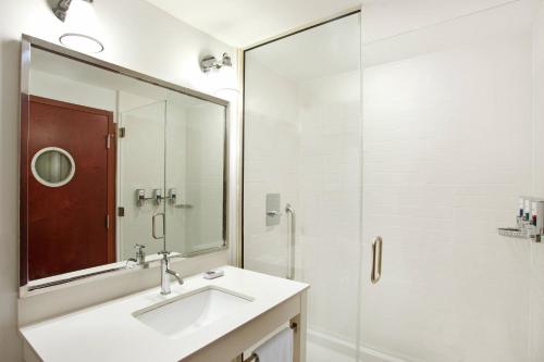 a bathroom with a sink and a glass shower at Four Points Philadelphia City Center in Philadelphia