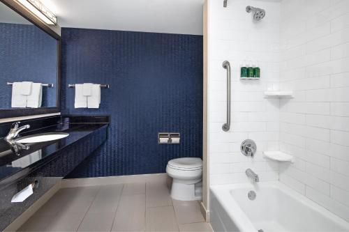 a bathroom with a tub and a toilet and a sink at Fairfield Inn & Suites by Marriott Toronto Mississauga in Mississauga