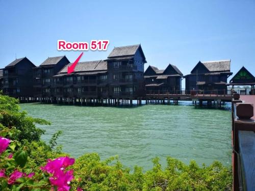 a row of wooden houses on the water at Langkawi Lagoon Hotel Resort in Kampung Padang Masirat