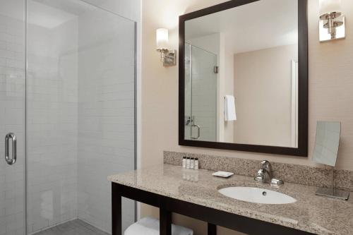 a bathroom with a sink and a shower at Delta Hotels by Marriott Guelph Conference Centre in Guelph