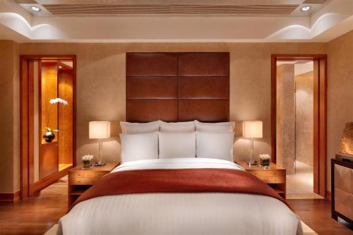 a bedroom with a large bed and two night stands at Nanning Marriott Hotel in Nanning