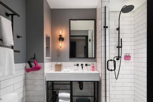 a bathroom with a sink and a shower at Moxy San Diego Gaslamp Quarter in San Diego