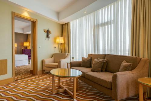 a living room with a couch and a table at Four Points by Sheraton Ikot Ekpene 