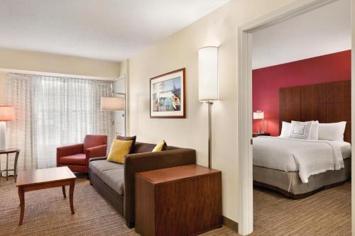 a hotel room with a bed and a couch at Residence Inn by Marriott Newport Middletown in Middletown