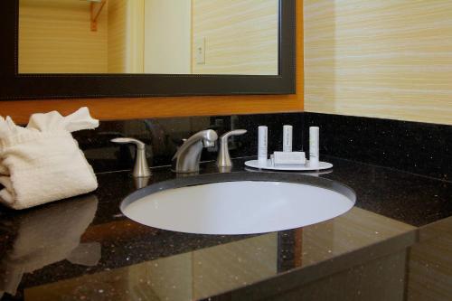 a bathroom with a sink and a mirror at Fairfield Inn & Suites By Marriott Jupiter in Jupiter