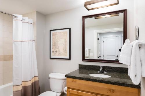 a bathroom with a sink and a toilet and a mirror at Marriott's Timber Lodge in South Lake Tahoe