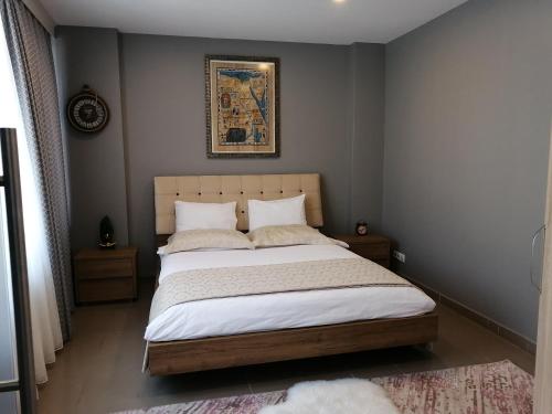 sypialnia z łóżkiem z obrazem na ścianie w obiekcie Levent Apartments w Stambule