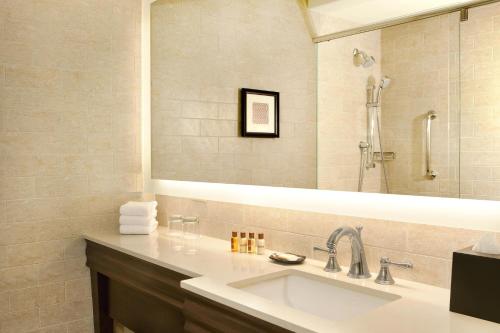 a bathroom with a sink and a large mirror at Sheraton Palo Alto Hotel in Palo Alto