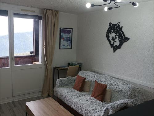 un salon avec un canapé et une fenêtre dans l'établissement Studio rénové proche des pistes avec terrasse et TV grand écran - FR-1-165A-98, à Uvernet