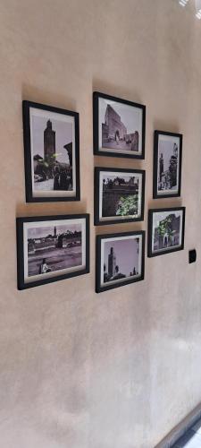 a group of pictures on a wall at Riad Al Nubala in Marrakech