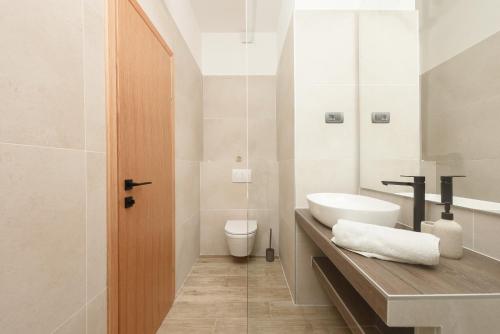 a bathroom with a sink and a toilet at NEW!Beautiful modern bedrooms and apt Old town Zadar- Great location in Zadar