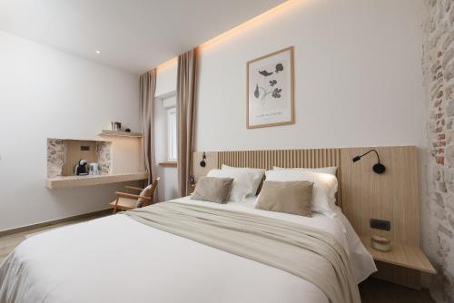 a bedroom with a large bed with white sheets at NEW!Beautiful modern bedrooms and apt Old town Zadar- Great location in Zadar