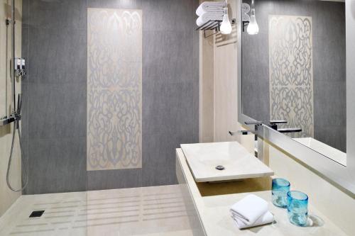 a bathroom with a sink and a mirror at Four Points By Sheraton Riyadh Khaldia in Riyadh