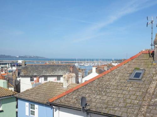 a view of roofs of buildings in a city at Plain Sailing 2 min walk to the harbour amazing location in Brixham