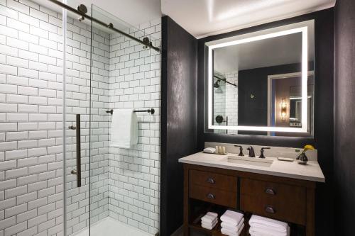 a bathroom with a sink and a shower with a mirror at Renaissance Philadelphia Downtown Hotel in Philadelphia