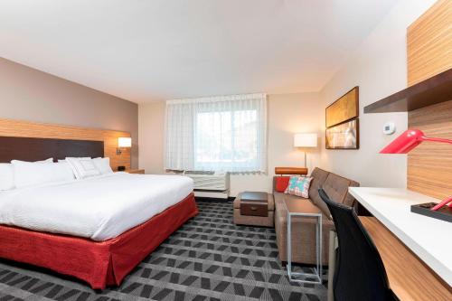 a hotel room with a bed and a desk at TownePlace Suites by Marriott Louisville North in Jeffersonville