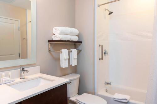a bathroom with a sink and a toilet and a shower at TownePlace Suites by Marriott Louisville North in Jeffersonville