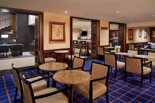 a restaurant with tables and chairs and a bar at Sheraton Ottawa Hotel in Ottawa