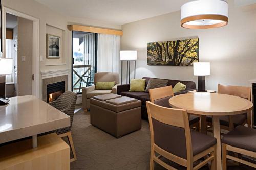 a living room with a couch and a table at Delta Hotels by Marriott Whistler Village Suites in Whistler