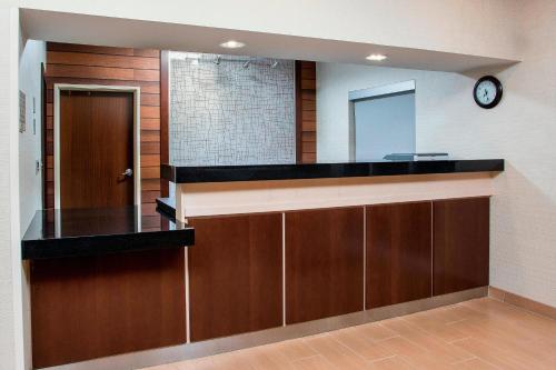 a bathroom with a counter with a mirror and a clock at Fairfield Inn & Suites Victoria in Victoria