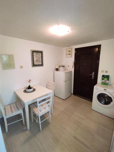 a small kitchen with a table and a washing machine at Bellus Apartment-COMPLETELY RENOVATED in Split