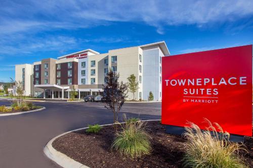 a hotel with a red sign in front of a building at TownePlace Suites by Marriott Knoxville Oak Ridge in Oak Ridge